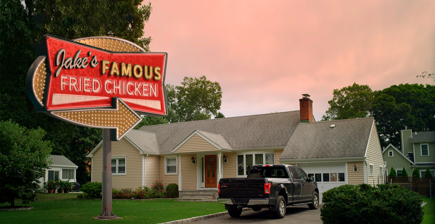 Jake's Famous Fried Chicken sign outside of a home