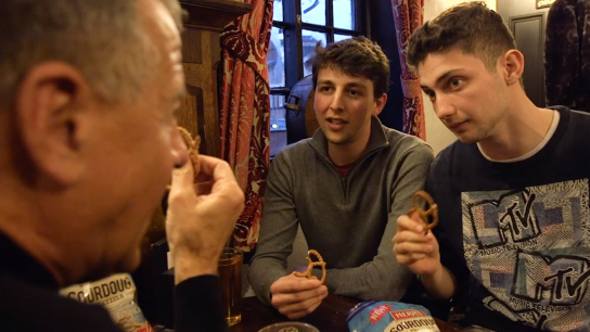 A group of men trying Herr's Sourdough pretzels in a pub