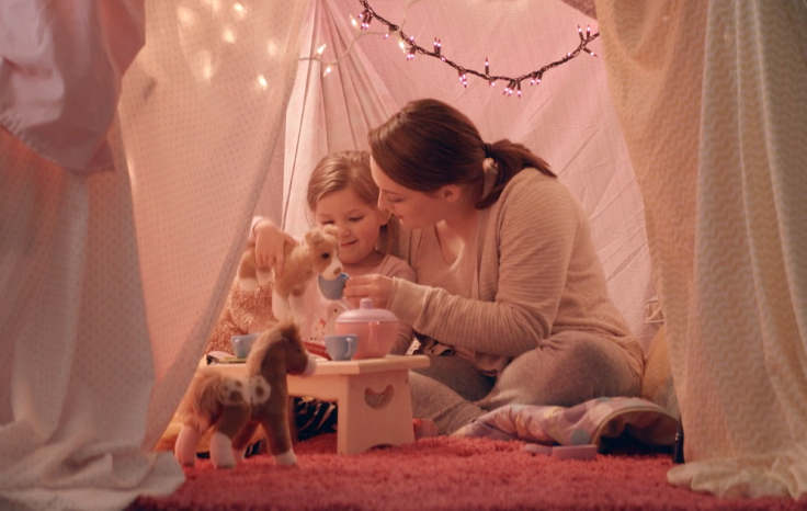 Mom and daughter playing together inside a blanket fort