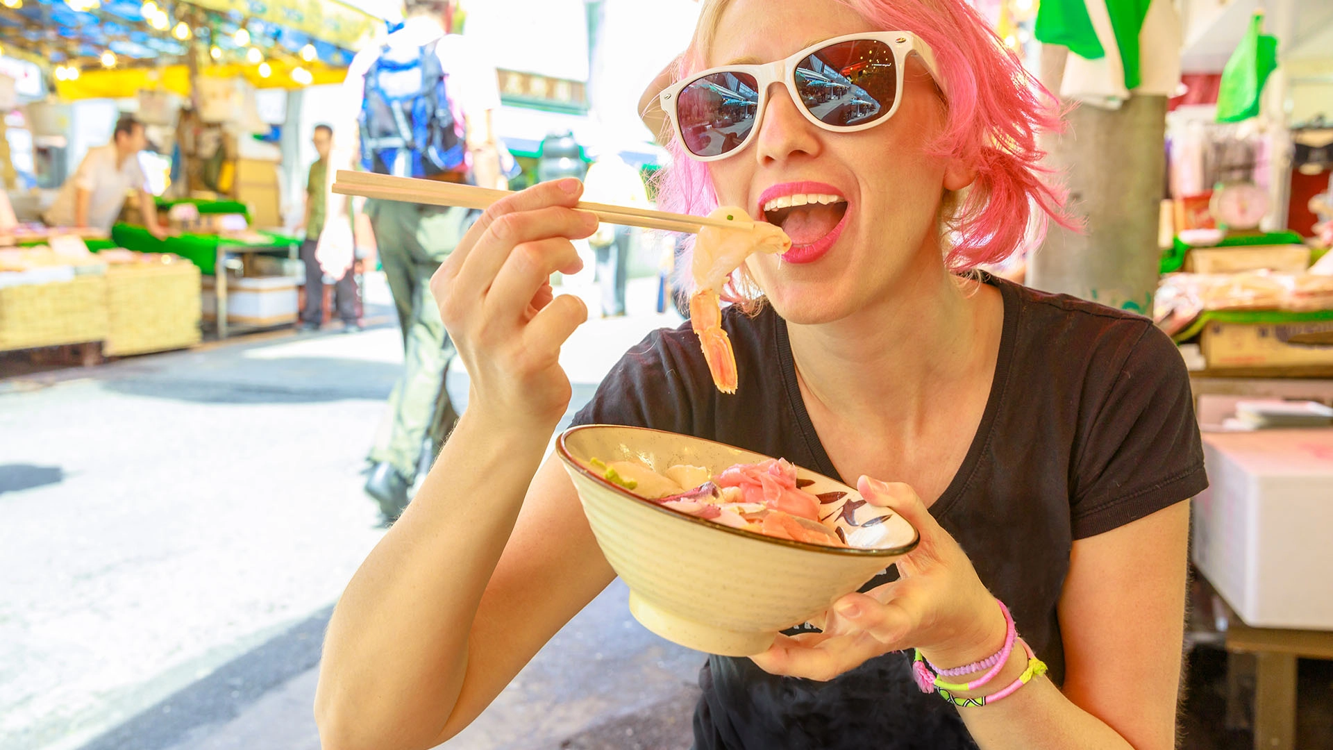 Woman with sun glasses eating food