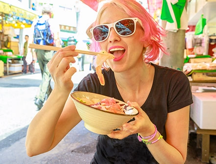 Woman with sun glasses eating food